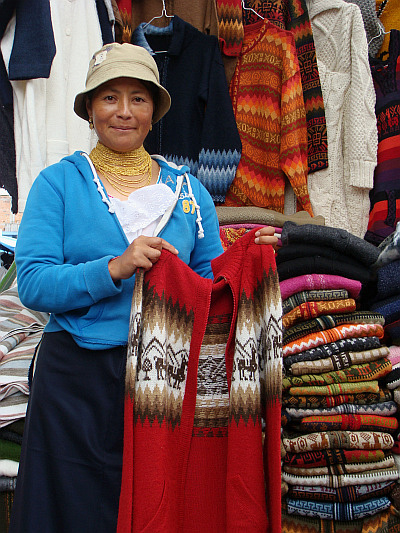 Otavaleña woman showing the alpaca wool sweater that I bought
