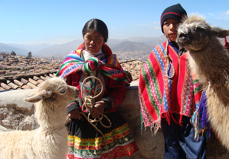 Children dress up in quasi traditional ponchos for tourists